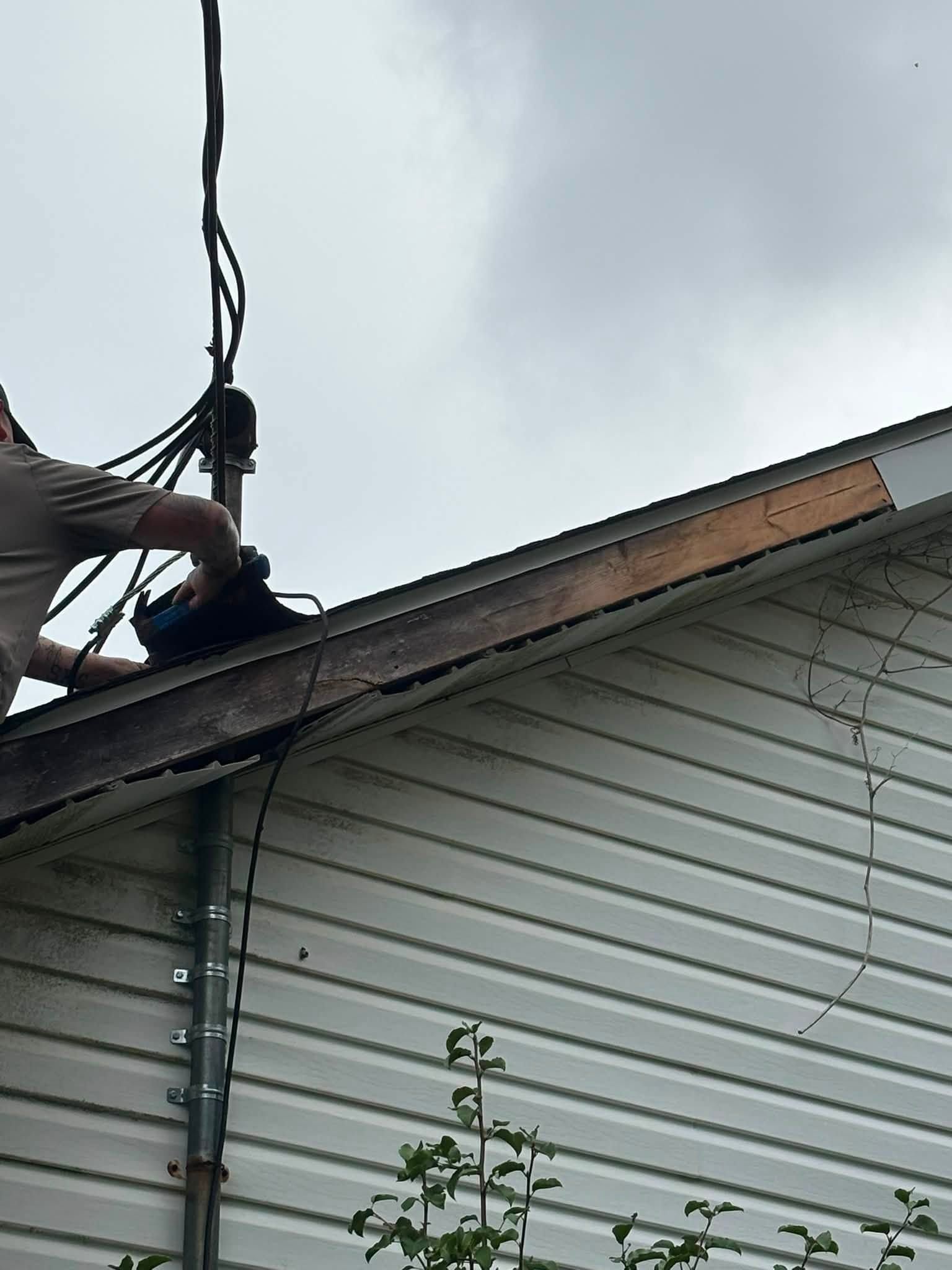 Close-up of the roof edge with the damaged fascia section opened up