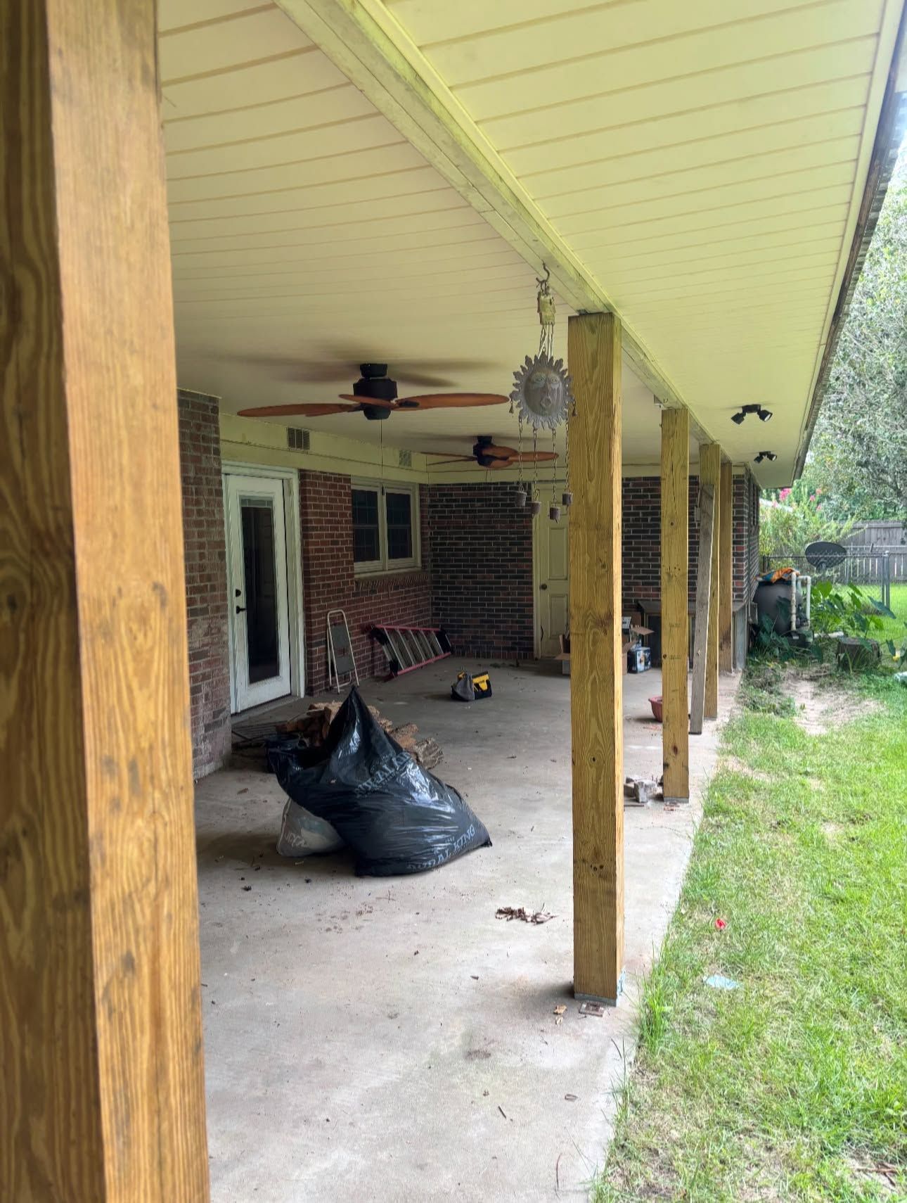 After: the same porch with a smooth white vinyl soffit ceiling and ceiling fans