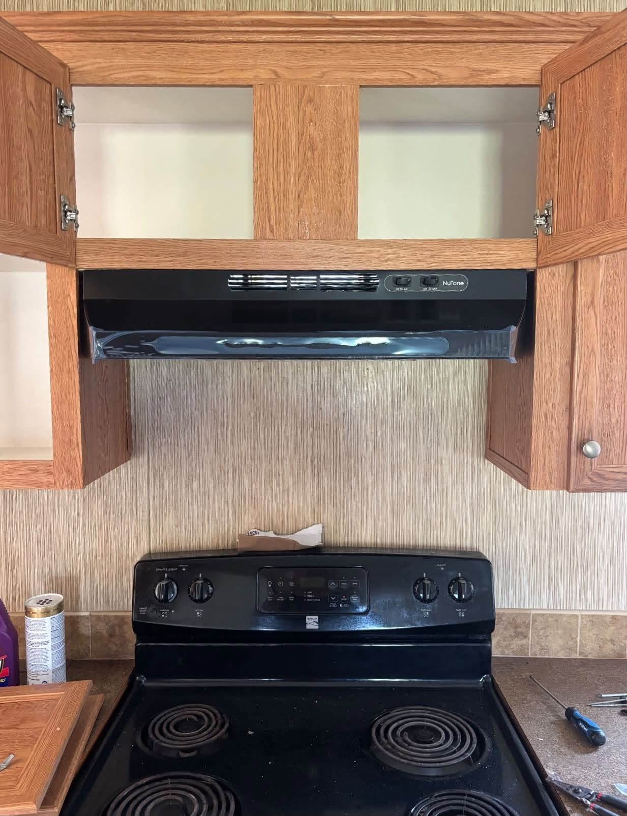 New range hood installed by REDLINE above an electric stove
